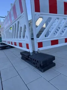 Mobile Defence - mobiler Sicherheitszaun - geschützte Technologie - 2 Bauzaunelemente in der Reihe gesichert - gesicherter Standfuss